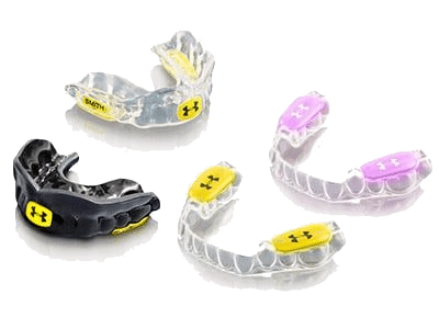 Four sports mouthguards in various colors, including black, yellow, and pink, with Under Armour logo visible on each.